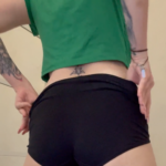 tattooed brunette thot takes off her shorts and bends over