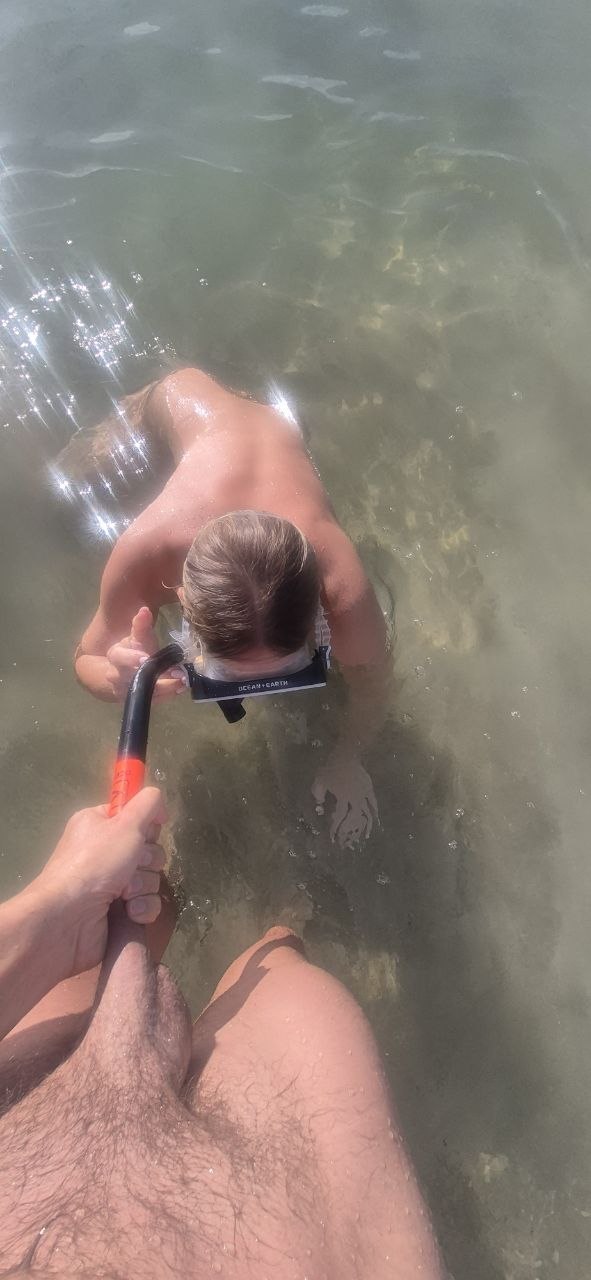couple skinny dipping at the beach